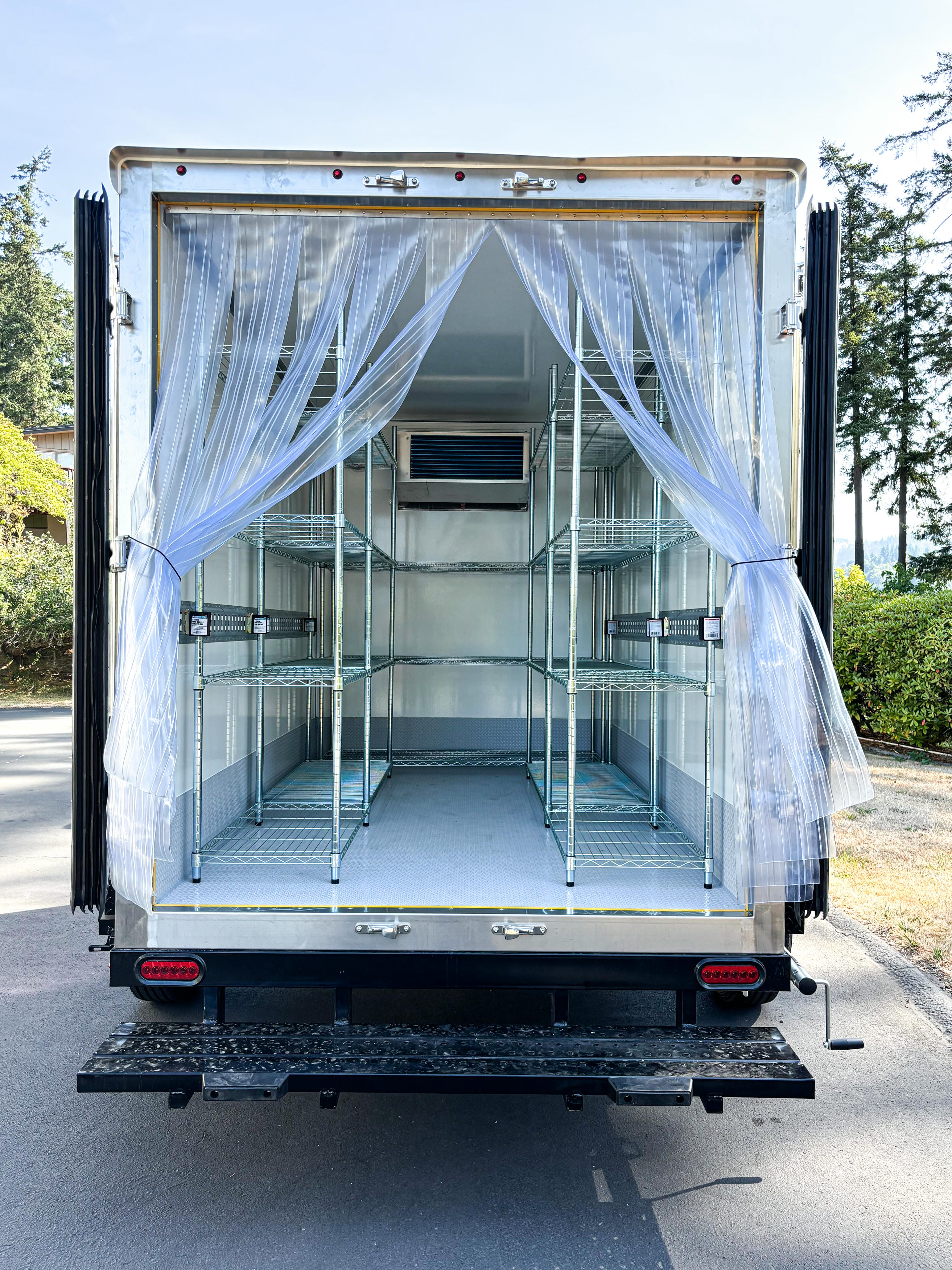 Refrigerated trailer rental interior rear entry with wire shelving and strip curtains for mobile cold storage Southwest Washington
